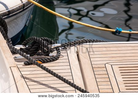 Dock Cleat On The Side Of A Boat In A Small Marina, An Element Of Yachting Equipment