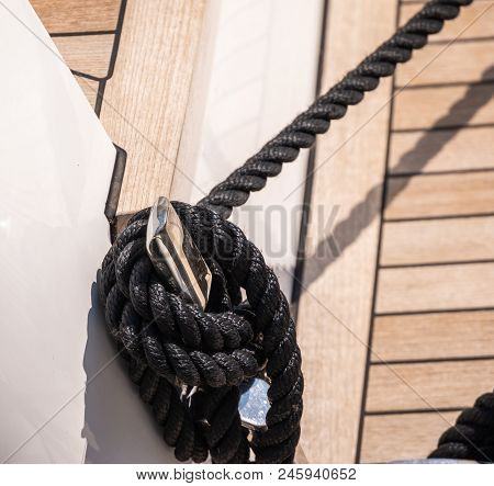 Dock Cleat On The Side Of A Boat In A Small Marina, An Element Of Yachting Equipment