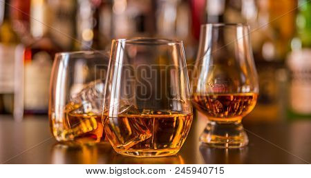 Scottish Whisky In A Glass With Ice Cubes, Golden Color Whiskey
