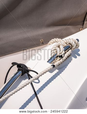 Dock Cleat On The Side Of A Boat In A Small Marina, An Element Of Yachting Equipment