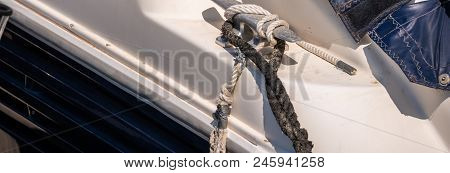 Dock Cleat On The Side Of A Boat In A Small Marina, An Element Of Yachting Equipment