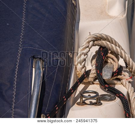 Dock Cleat On The Side Of A Boat In A Small Marina, An Element Of Yachting Equipment