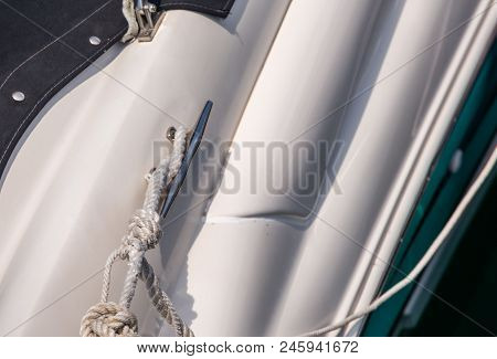 Dock Cleat On The Side Of A Boat In A Small Marina, An Element Of Yachting Equipment