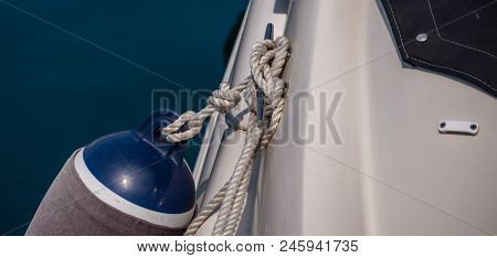 Dock Cleat On The Side Of A Boat In A Small Marina, An Element Of Yachting Equipment
