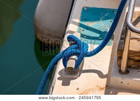 Dock Cleat On The Side Of A Boat In A Small Marina, An Element Of Yachting Equipment