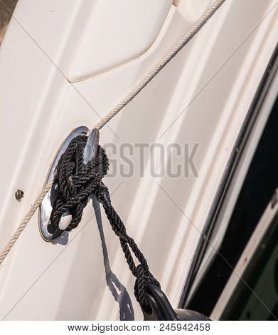 Dock Cleat On The Side Of A Boat In A Small Marina, An Element Of Yachting Equipment