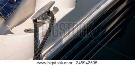 Dock Cleat On The Side Of A Boat In A Small Marina, An Element Of Yachting Equipment