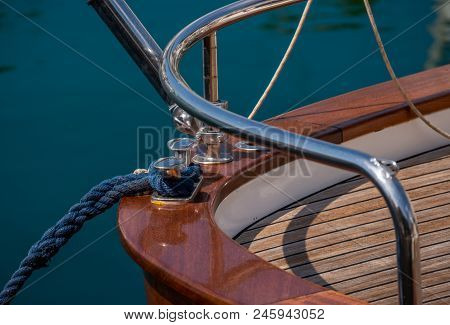 Dock Cleat On The Side Of A Boat In A Small Marina, An Element Of Yachting Equipment