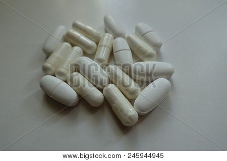 Few White Capsules Of Magnesium Citrate And Caplets Of Calcium Citrate