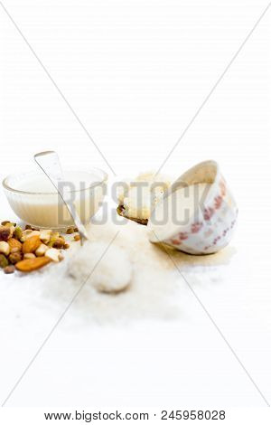 Entire Ingredients For Suji Ka Halwa Isolated On White Including Milk And Dry Fruits.