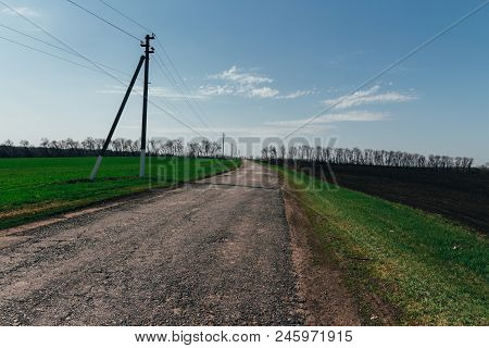 Plowed Field On Which Agricultural Machinery Rides. Summer Day Two Tractors To Plow, Plow The Soil O