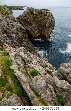 Coastal cliffs near of the beach Gulpiyuri, Asturias, Spain