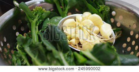 Selective Focus On Food Ingredient, Garlic In Vegetable Metal Colander Or Cullender