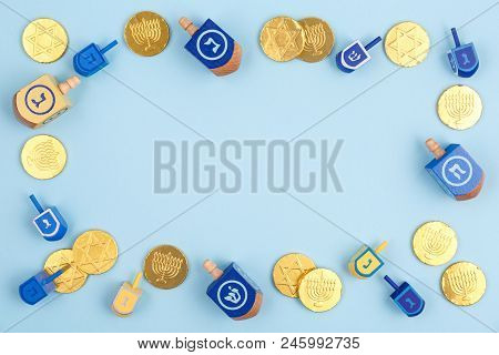 Blue Background With Multicolor Dreidels, Menora Candles And Chocolate Coins. Hanukkah And Judaic Ho