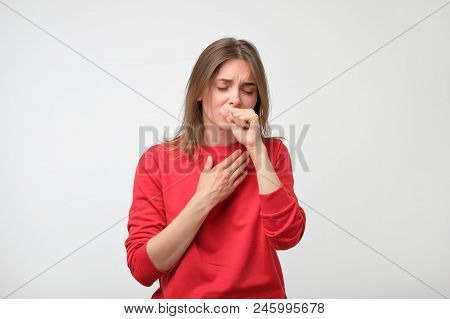 Unhappy Caucasian Woman In Red Pulover Suffering From Throat Pain At Home. Concept Of Being Ill And 