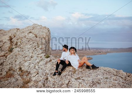 Romantic Summer Love Story On A Sunset In Mountains. Young Girl And Boy In Love.