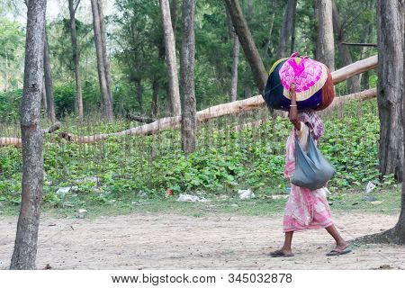 A Tribal Woman Carry Belongings On Head, Going To Check Her Name On Final List Of National Register 