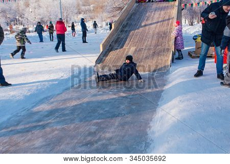 Novokuznetsk, Russia- January 07, 2019: Russian Winter Entertainment: Children Having Fun Tobogganin