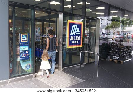 Lugano, Ticino, Switzerland - 19th August 2019 : People Entering A Aldi Supermarket Shop In Switzerl