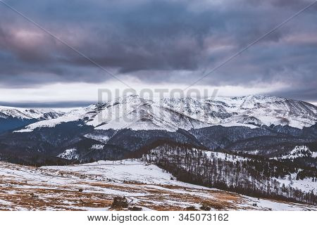 Mountain Range With Visible Silhouettes Through The Morning Colorful Fog.tarcu Mountains In Romania.