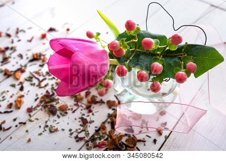 Flower Decoration With Pink Tulip And Dried Blossoms On White Vintage Wooden Table. Close-up For A M