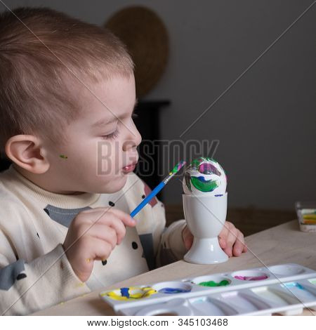Toddler Boy Painting Easter Eggs Preparing For Holidays. Easter Tradition