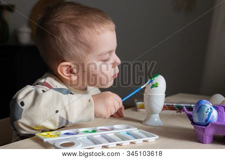 Toddler Boy Painting Easter Eggs Preparing For Holidays. Easter Tradition