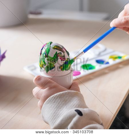 Toddler Boy Painting Easter Eggs Preparing For Holidays. Easter Tradition