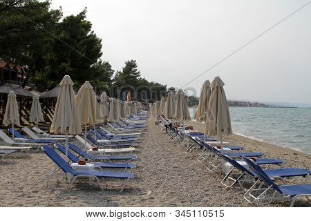 Sand Beach With Sun Beds And Parasols