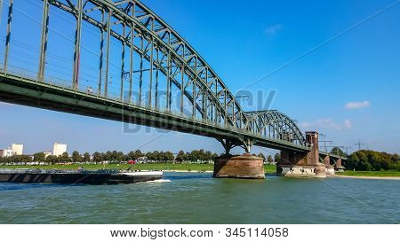 A Tanker Sails On The Rhine Under The South Bridge In Cologne, Germany
