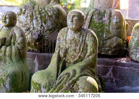 Statue Of A Seated Buddhist Monks Made Of Stone Close-up