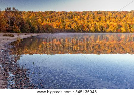 Autumn Lake Reflections. Vibrant Fall Colors Reflected In The Northern Michigan Monocle Lake At The 