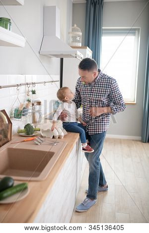 Cute Little Girl In A White Shirt Looking At Her Father
