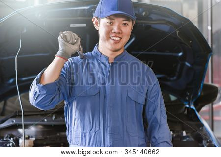 Man Mechanic Inspection Hold Wrench For Fix Blue Car For Service Maintenance Insurance With Car Engi