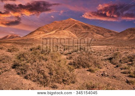 View To The Volcanic Mountain Hacha Grande Near Papagayo Beach In Lanzarote, Spain During Sunset