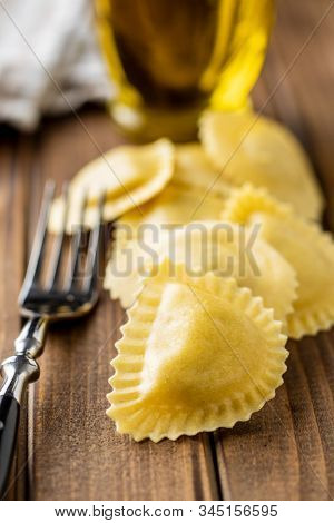 Italian stuffed pasta. Panzerotti pasta on wooden table.