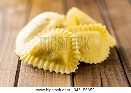 Italian stuffed pasta. Panzerotti pasta on wooden table.