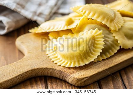 Italian stuffed pasta. Panzerotti pasta on cutting board.