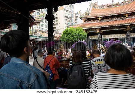 Taipei, Taiwan - October 20th, 2019: people praying in Lungshan temple at Taipei, Taiwan