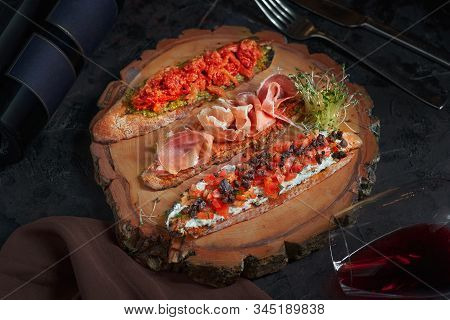 Brushetta Set For Wine. Variety Of Small Sandwiches With Prosciutto, Tomatoes, Parmesan Cheese, Fres
