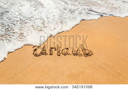 Hand Written Text In German Urlaub, English Translation Holidays, On The Golden Beach Sand With Comi