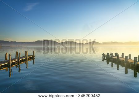 Two Wooden Piers Or Jetties And Lake At Sunrise. Torre Del Lago Puccini, Versilia, Massaciuccoli Lak
