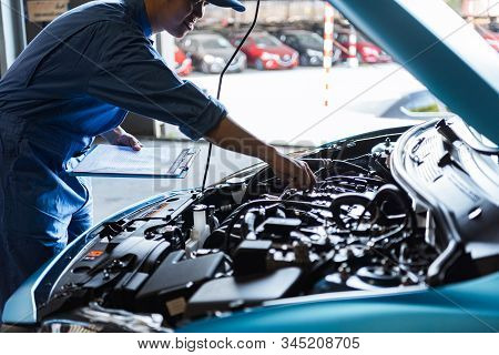 Car Mechanic Holding Clipboard And Checking To Maintenance Vehicle By Customer Claim Order In Auto R