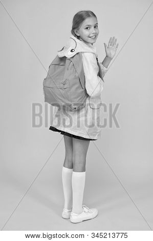 Rain Is Not Hindrance. Schoolgirl Raincoat Going To School Waving Hand. Waterproof Fabric For Your C