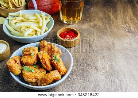 Table Fof Tasty Snacks And Beer Prepared For Watching Sports On Tv. Selective Focus