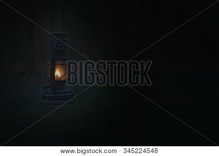 Vintage Kerosene Oil Lantern Lamp Burning With A Soft Glow Light In An Dark Forest / Wood. Light In 