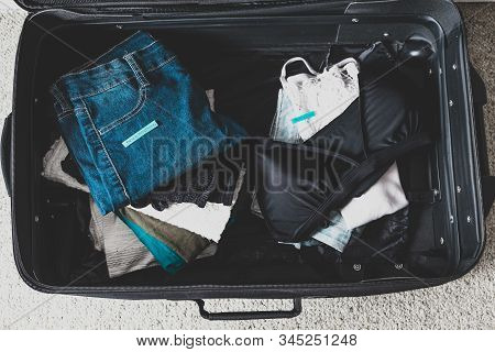 Luggage With Two Pile Of Clothes And Packing Everything Vs Pack Light Labels On Them
