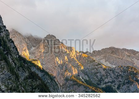 Morning Sun Illuminating A Lush Mountain Valley.