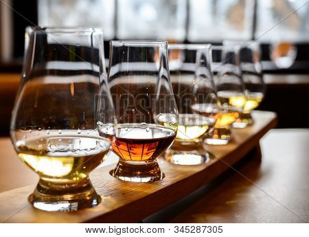 Scotch Whisky, Tasting Glasses With Variety Of Single Malts Or Blended Whiskey Spirits On Distillery