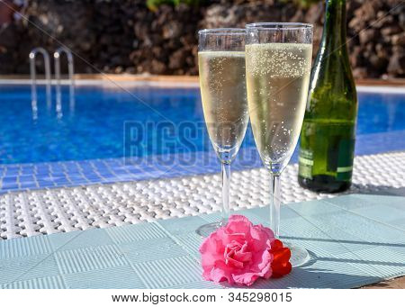 Pool Party With Two Glasses Of Bubbles White Champagne Or Cava Wine, Romantic Event On All Inclusive